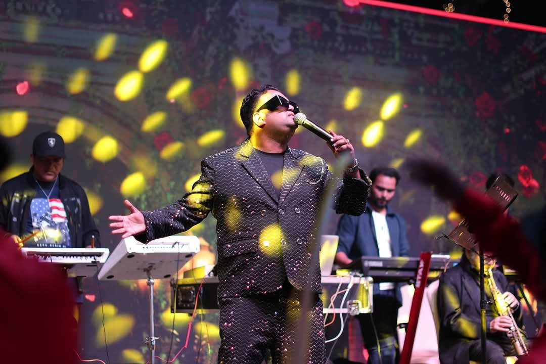 Vaibhav Pewal singing on stage under yellow lights