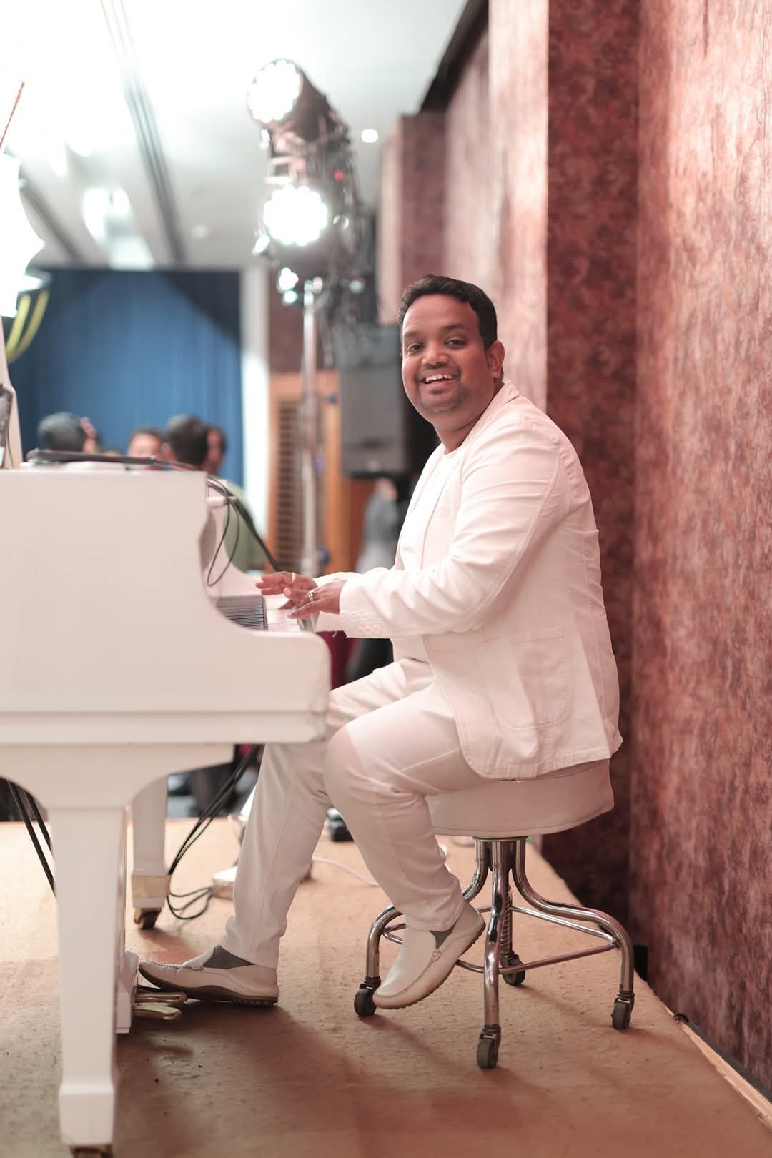 Vaibhav Pewal in white at the grand piano