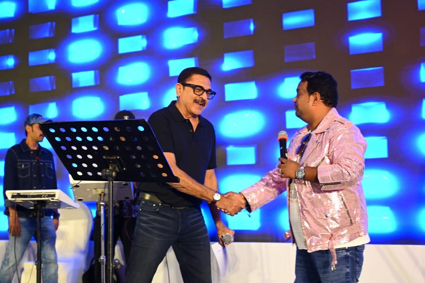 Vaibhav Pewal greeting a celebrity guest on stage